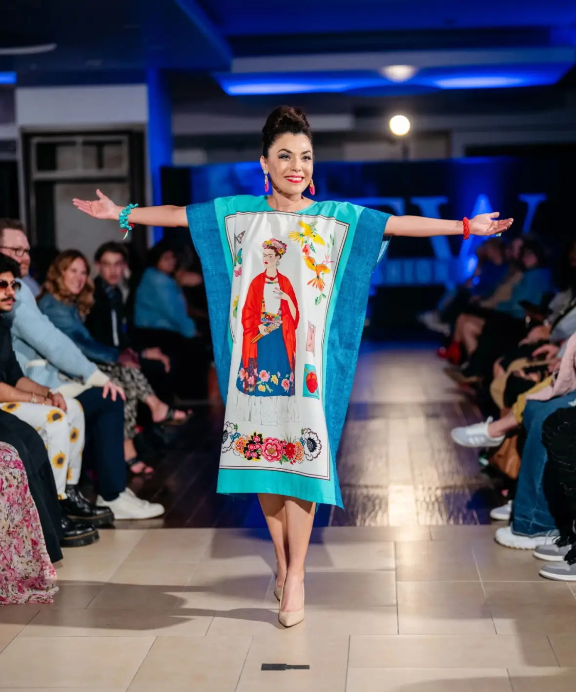 Woman showcasing artistic garment on catwalk